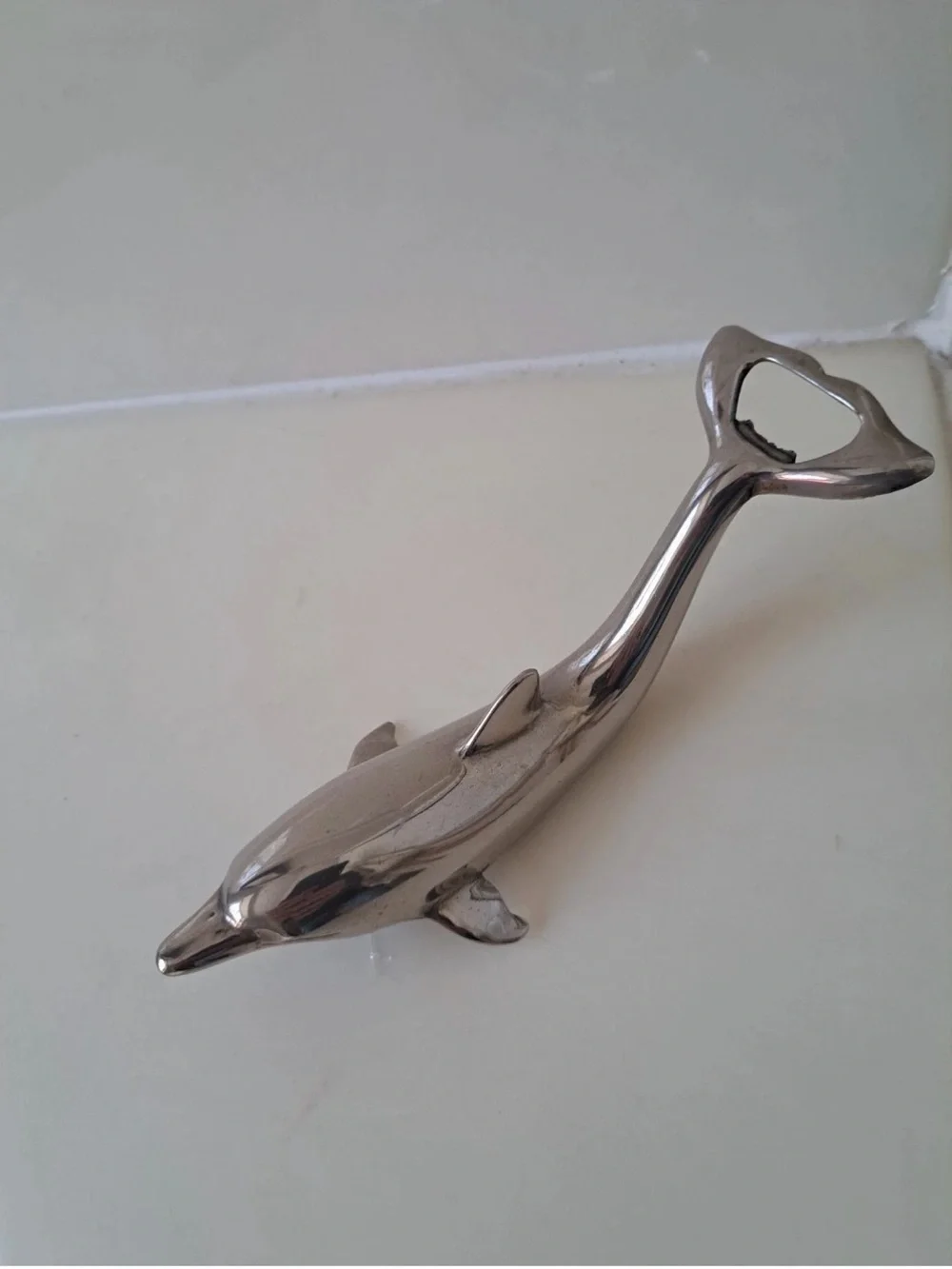 Sleek silver-plated Dolphin bottle opener